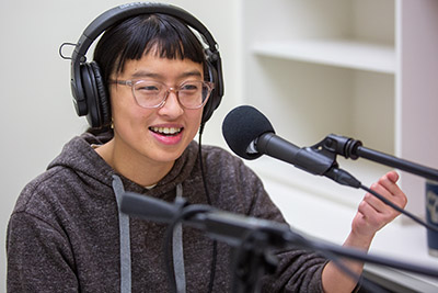Michelle Chung at a podcasting microphone